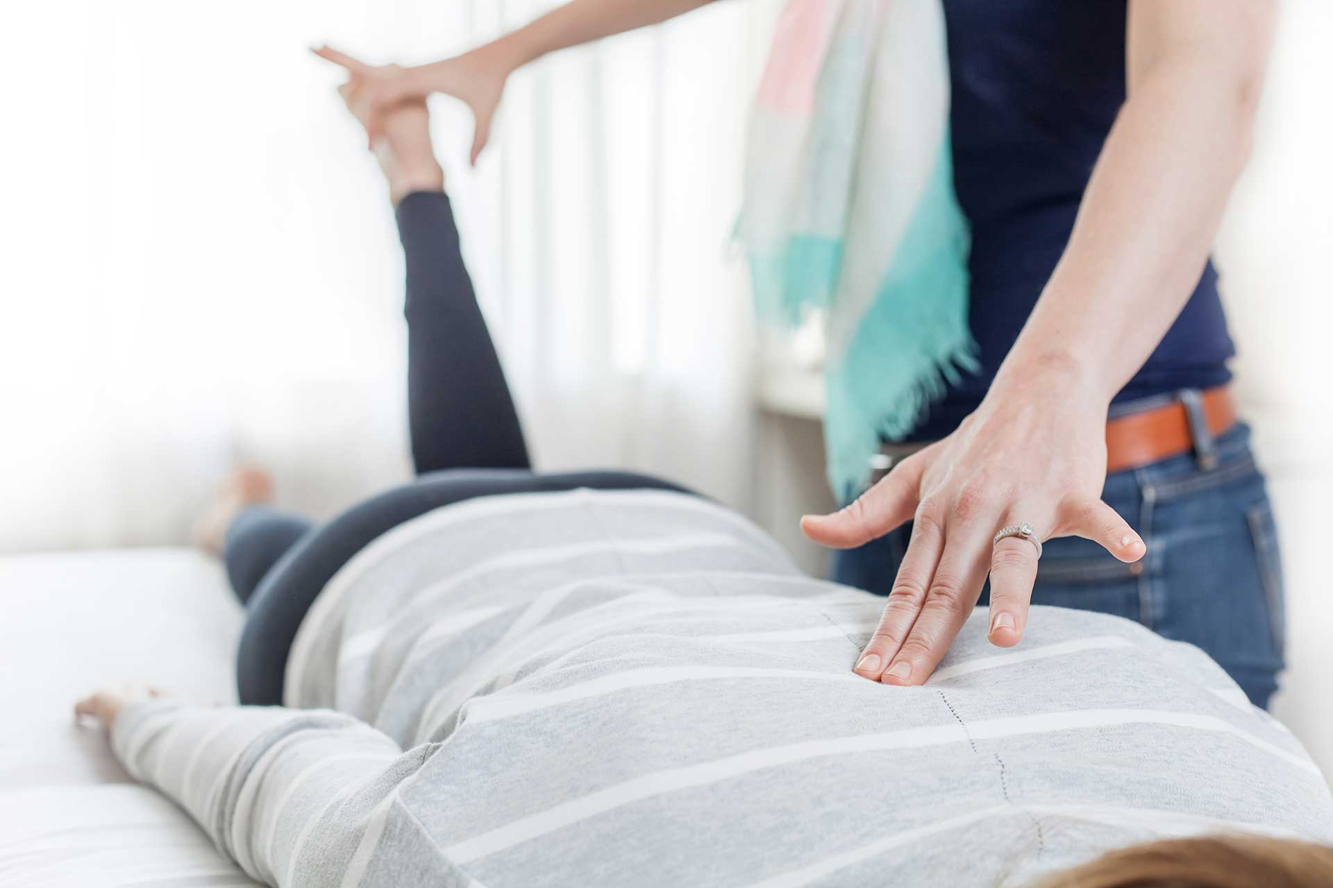 Practitioner performing kinesiology on patient