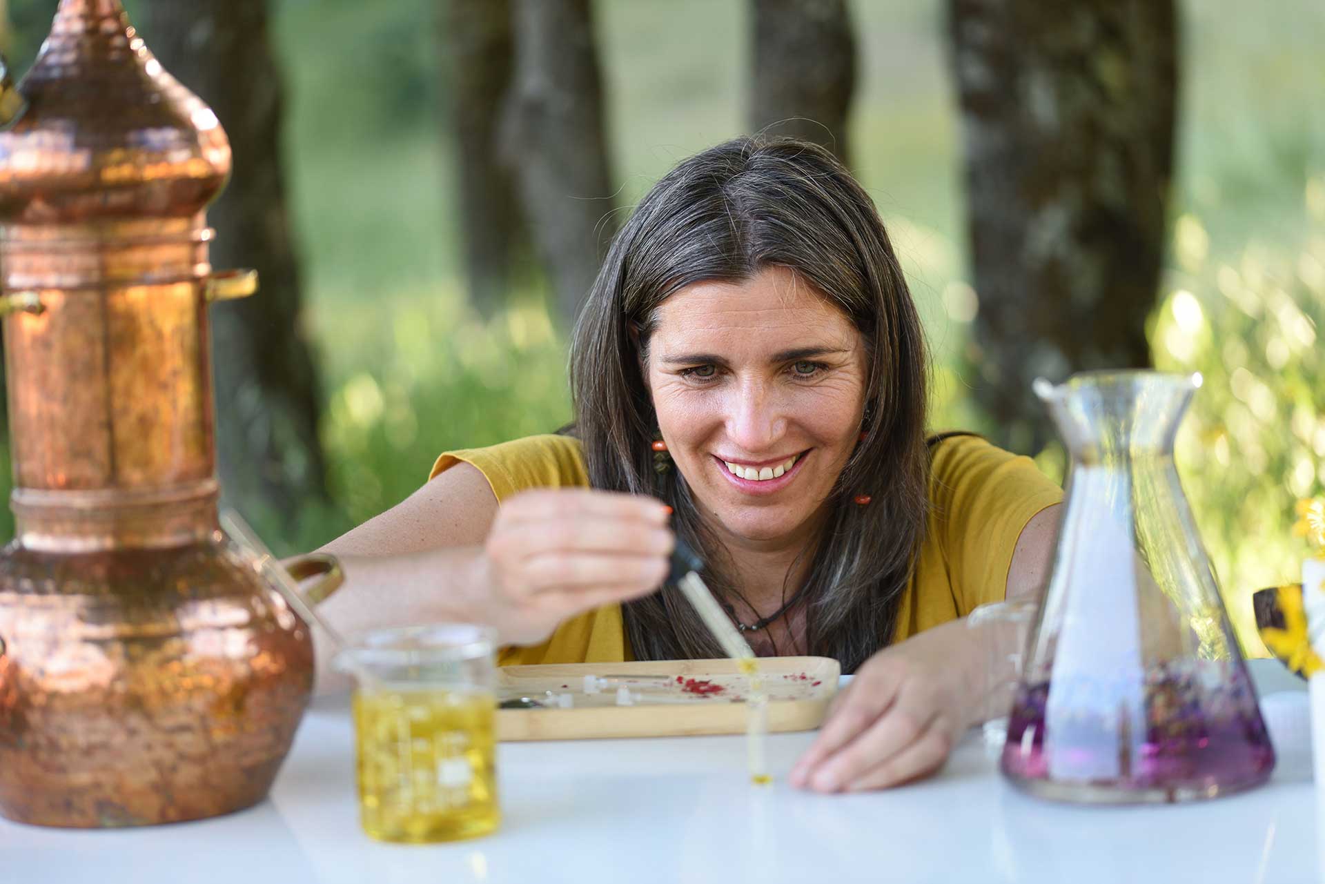 Woman measuring oils and herbs